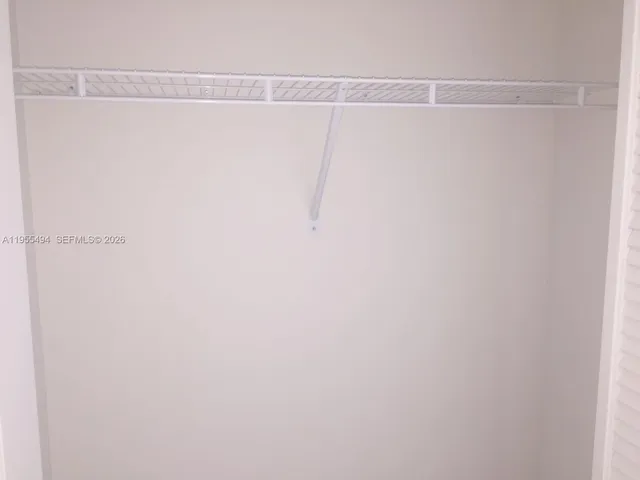 an empty room with sliding door and window