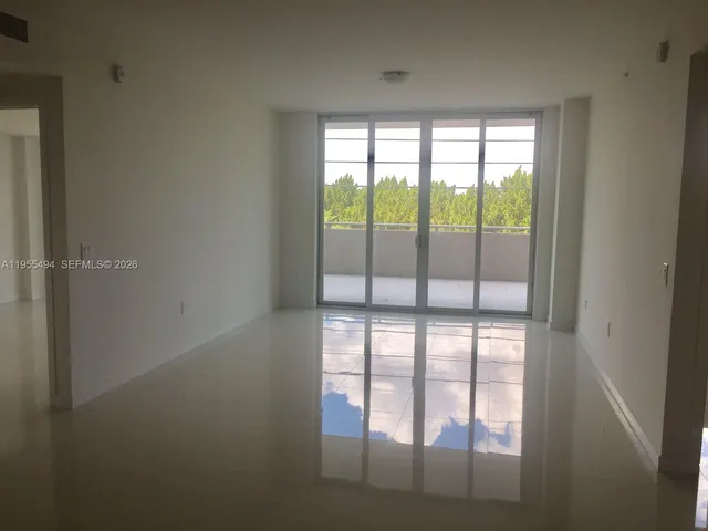 a view of empty room with large windows