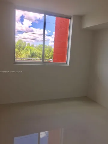 an empty room with closet area