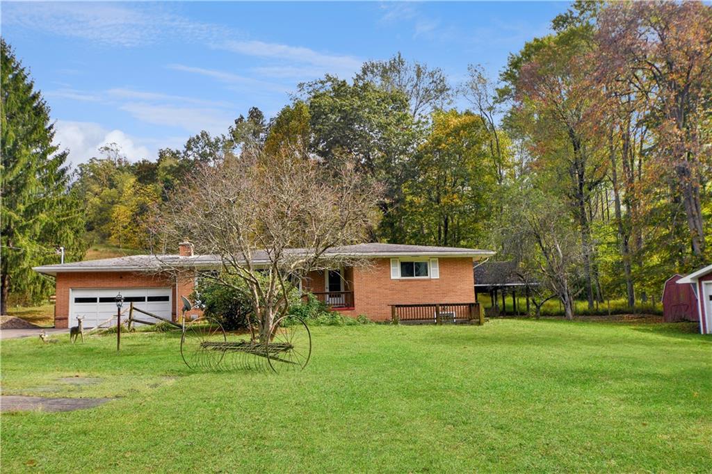 222 Gas Company Road Mount Morris, PA 15349 - Photo 3 of 34 a front view of house with a garden and trees
