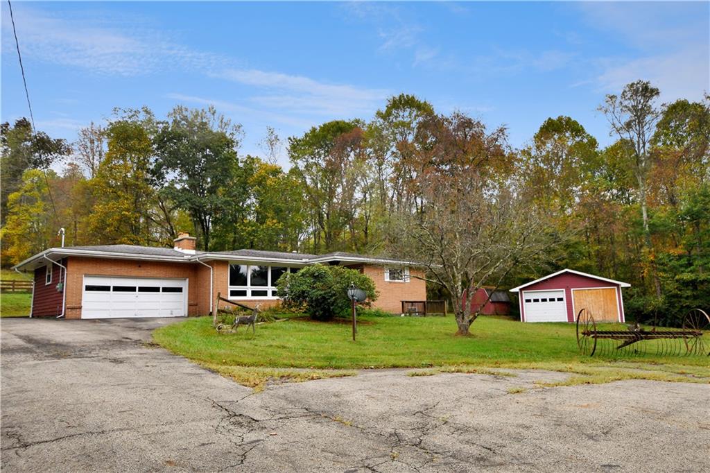 222 Gas Company Road Mount Morris, PA 15349 - Photo 6 of 34 a front view of a house with a yard and trees