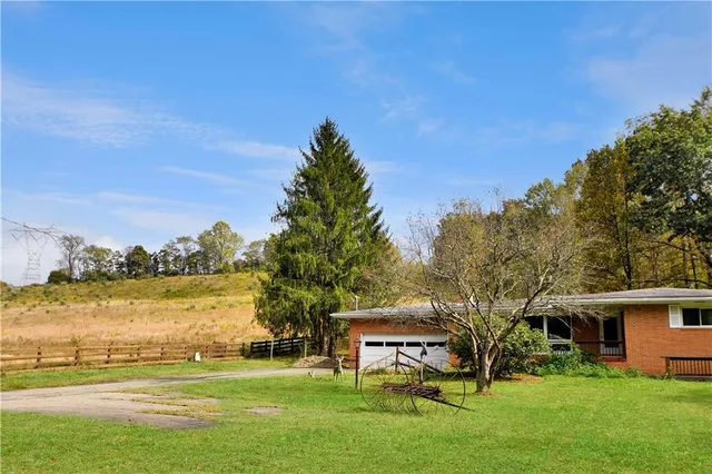 a view of a house with a yard and lake view