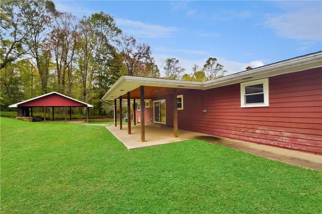 a view of a house with a yard porch and sitting area