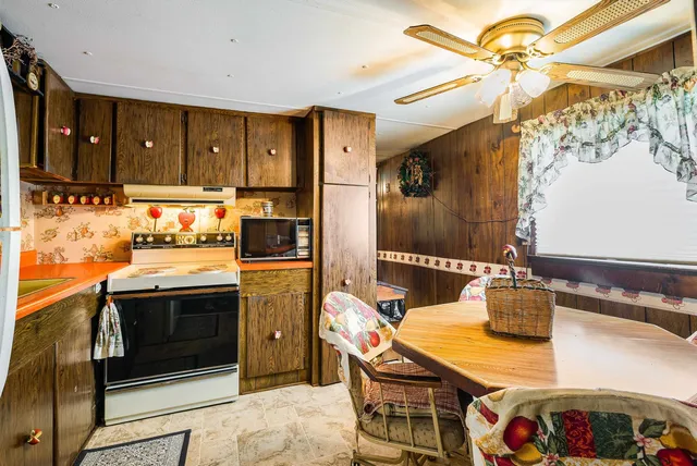 a kitchen with a sink appliances and cabinets