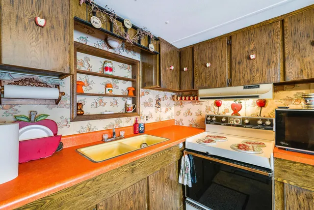 a kitchen with a sink and a stove top oven