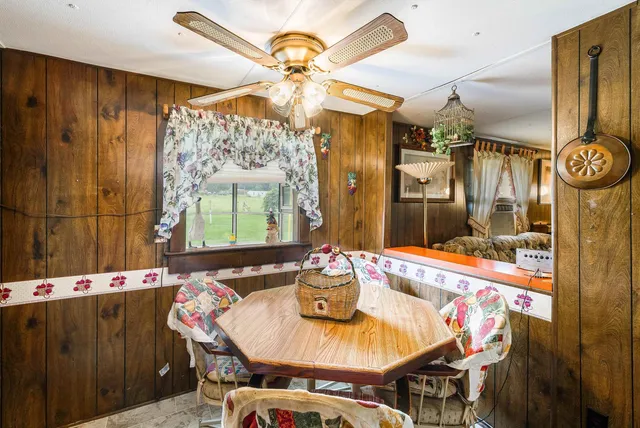 a dining room with furniture and window