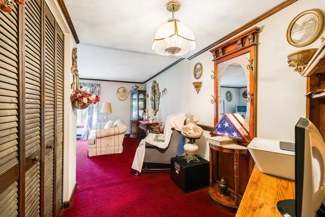 a living room with furniture and a chandelier