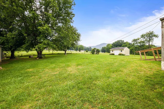 a house view with swimming pool in front of it