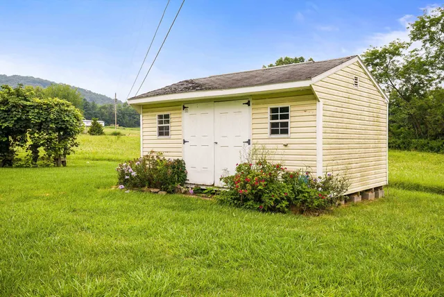a view of a house with backyard and sitting area