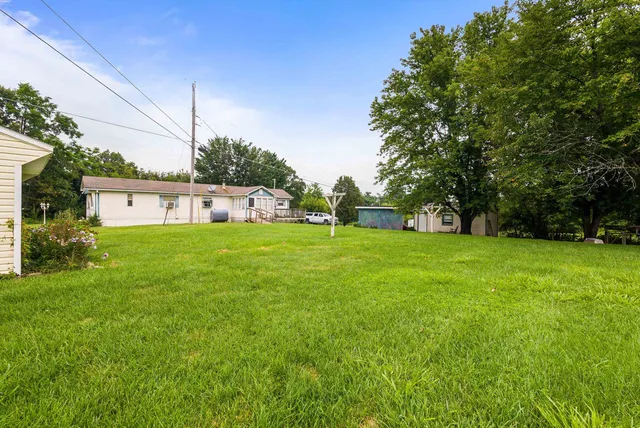 a view of a house with a yard and sitting area