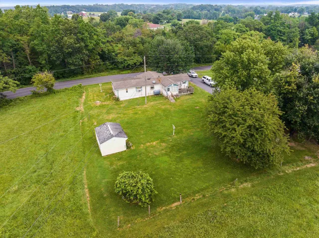an aerial view of residential houses with outdoor space and swimming pool