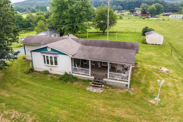 a aerial view of a house with swimming pool and a garden