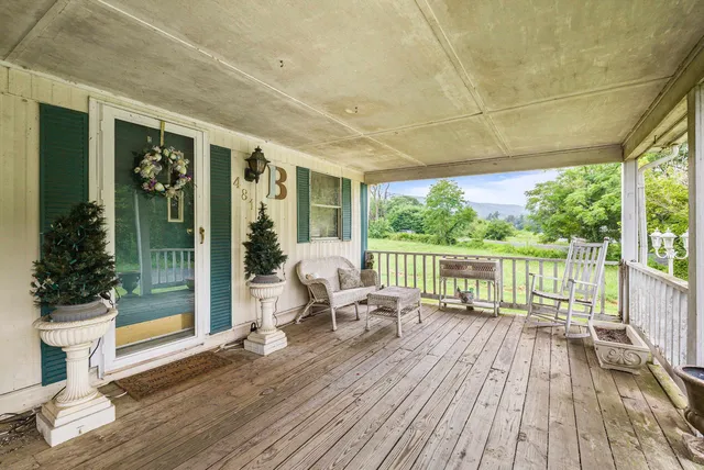 a balcony with wooden floor and outdoor space