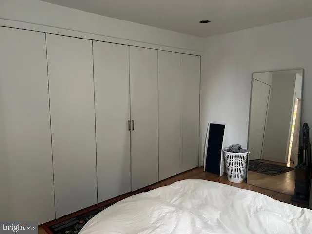 a bedroom with a bed and a mirror