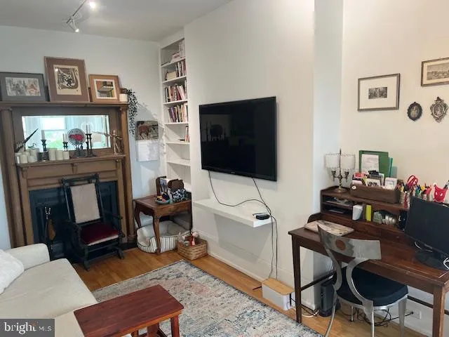 a living room with furniture a flat screen tv and a dining table