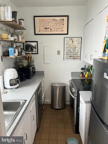 a kitchen with a sink cabinets and appliances