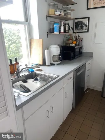 a kitchen with a sink cabinets and window