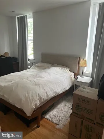 a bed sitting in a bedroom next to a window