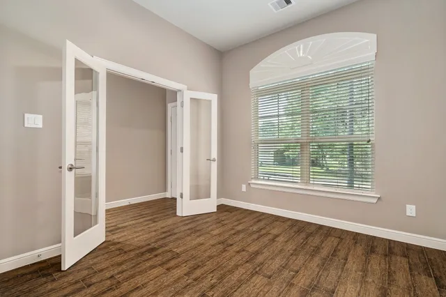 a kitchen with granite countertop a sink cabinets and wooden floor