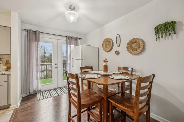 a view of a dining area with furniture and a large window