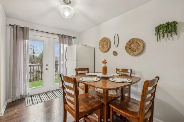 a view of a dining area with furniture and a large window