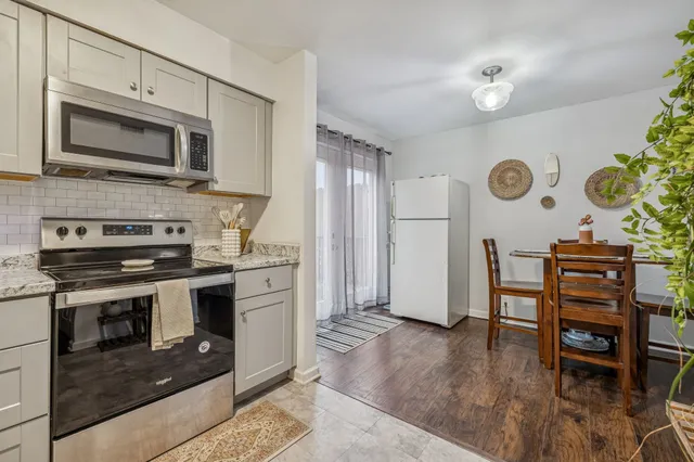 a kitchen with stainless steel appliances granite countertop a stove and a microwave