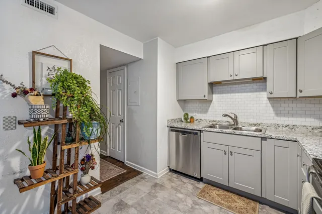a kitchen with a sink a stove and cabinets