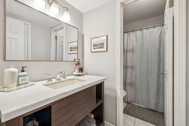 a bathroom with a sink a vanity and a mirror