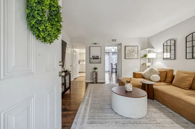 a living room with furniture and a potted plant