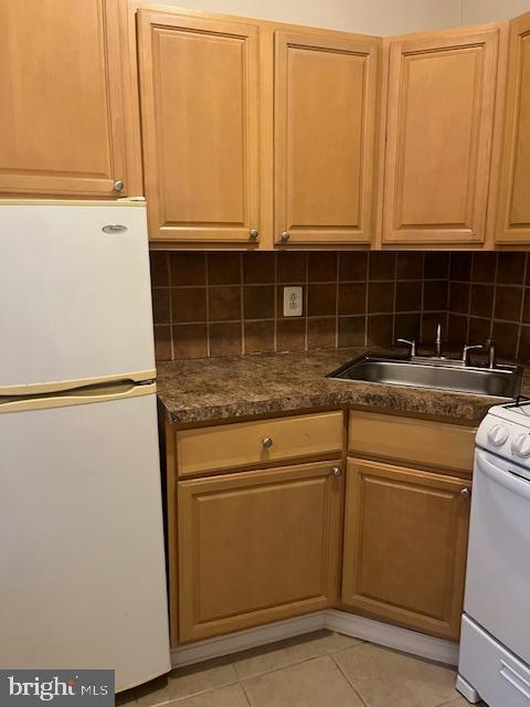 4232 Chestnut Street, Unit 2REAR Philadelphia, PA 19104 - Photo 5 of 7 a kitchen with stainless steel appliances granite countertop a sink a refrigerator and cabinets