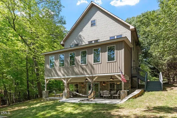 a view of a house with a backyard porch and sitting area