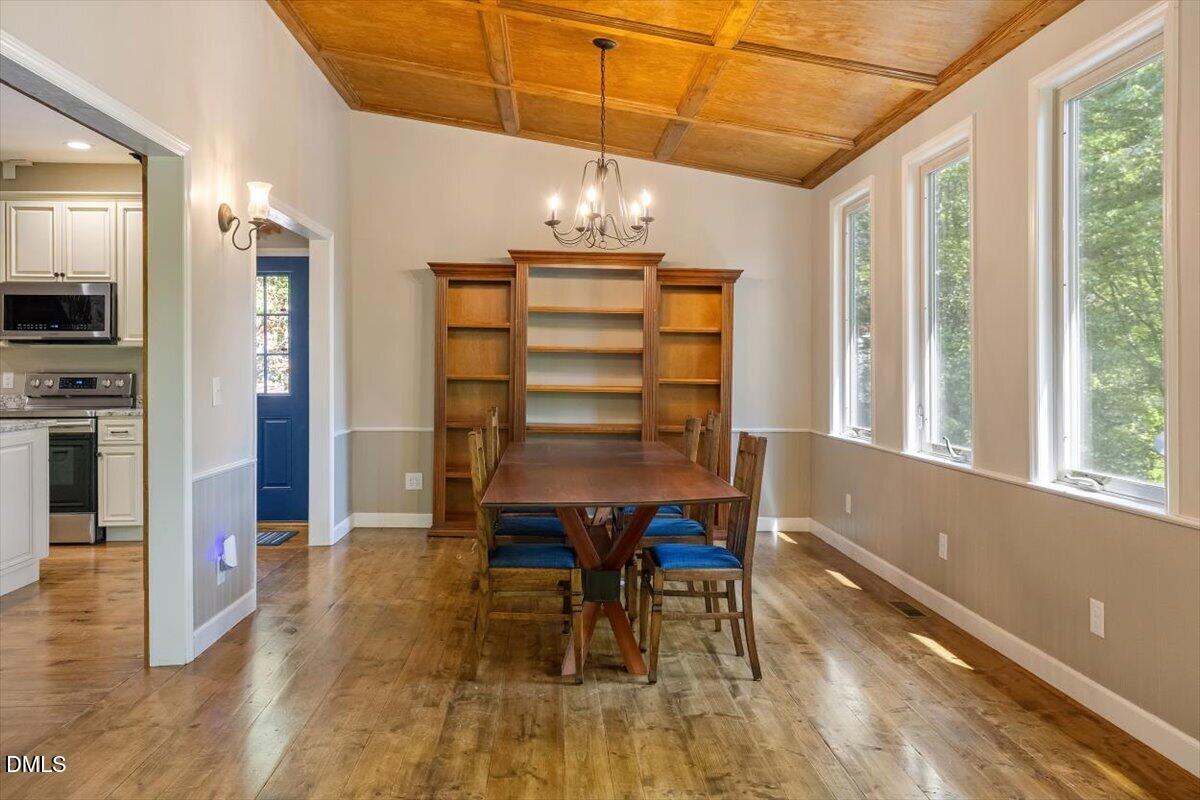 160 Stillwater Lane Roxboro, NC 27574 - Photo 11 of 57 a view of a dining room with furniture and wooden floor