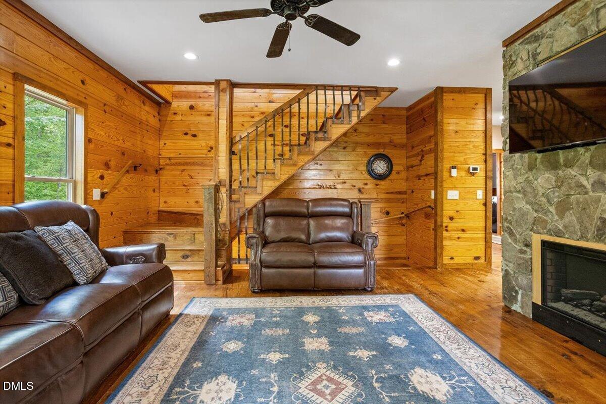 160 Stillwater Lane Roxboro, NC 27574 - Photo 15 of 57 a living room with furniture a fireplace and a flat screen tv
