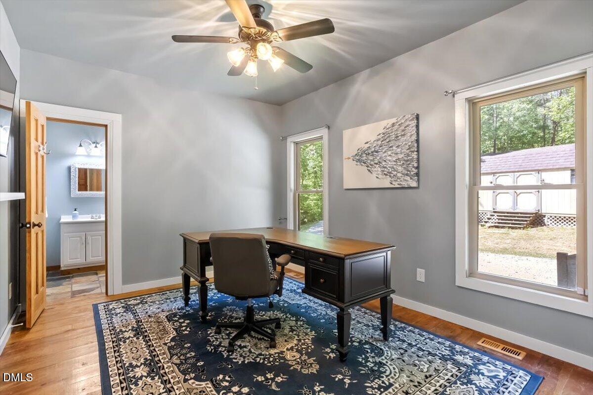160 Stillwater Lane Roxboro, NC 27574 - Photo 17 of 57 a workspace with wooden floor and a window