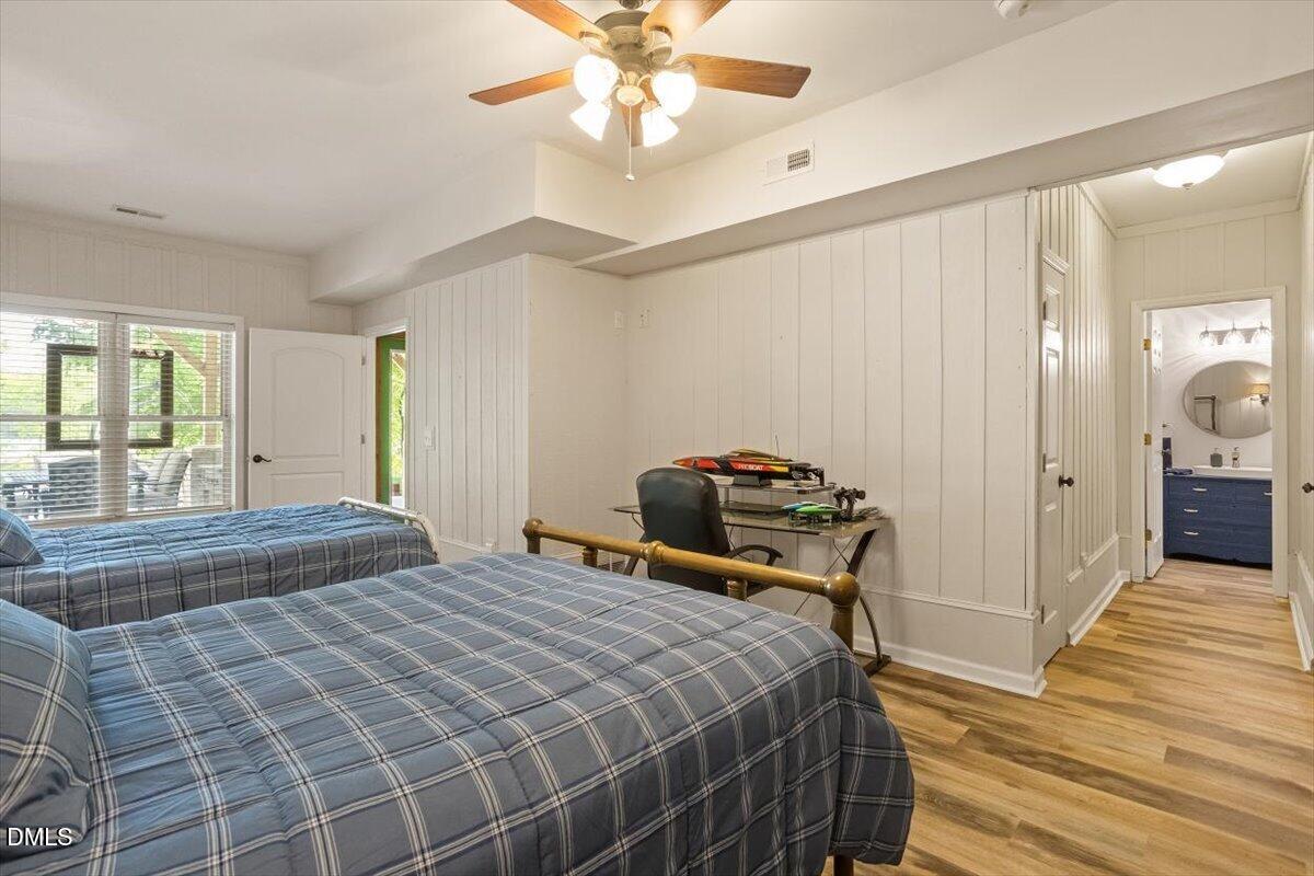 160 Stillwater Lane Roxboro, NC 27574 - Photo 28 of 57 a bedroom with a bed and a chandelier