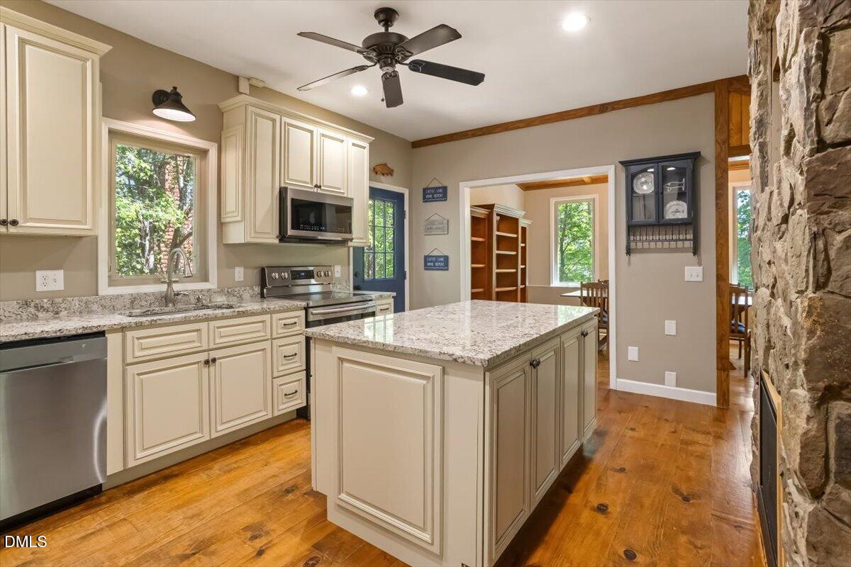 160 Stillwater Lane Roxboro, NC 27574 - Photo 5 of 57 a kitchen with a stove a sink and a refrigerator