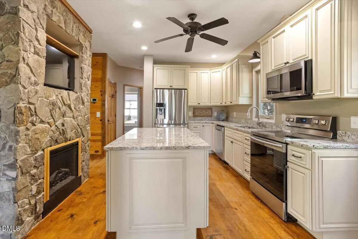 160 Stillwater Lane Roxboro, NC 27574 - Photo 6 of 57 a kitchen with stainless steel appliances granite countertop a stove top oven a sink and a microwave