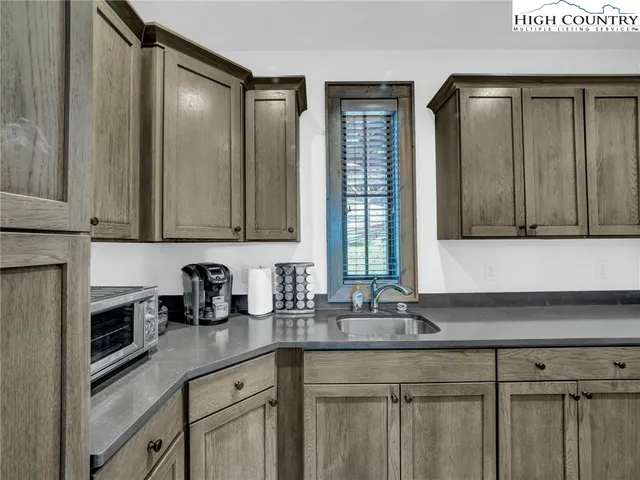 a kitchen with stainless steel appliances granite countertop a sink and a granite counter tops