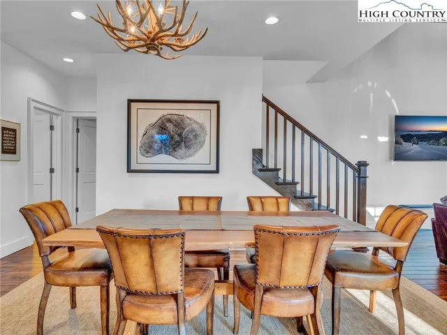 a dining room with furniture and wooden floor