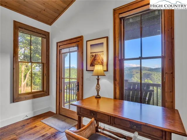a view of a room with a window and wooden floor