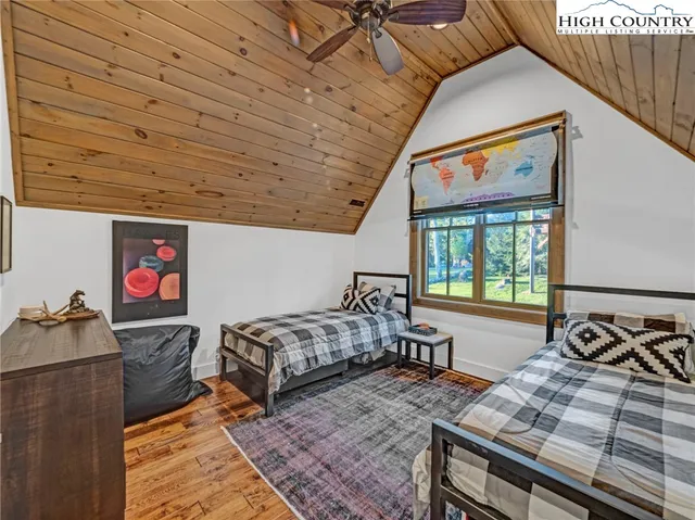 a bed sitting in a bedroom next to a window