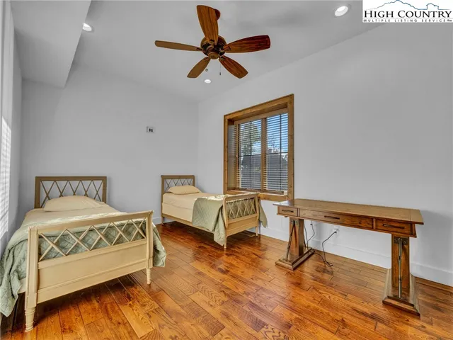 a bedroom with a bed a dresser and a window