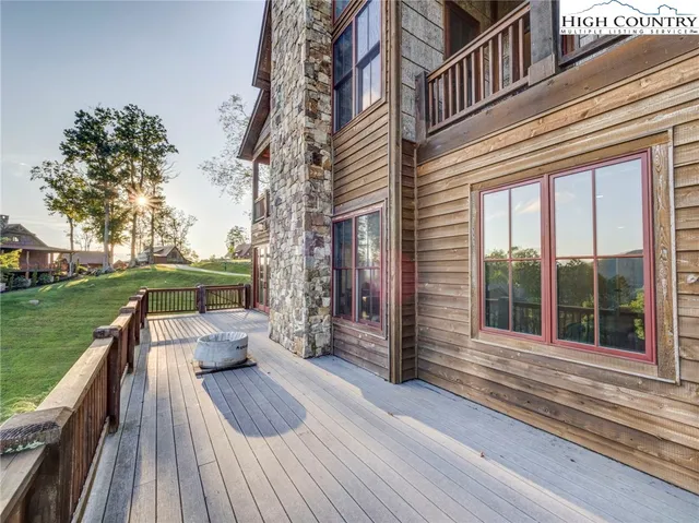 a view of a roof deck with couches and wooden floor