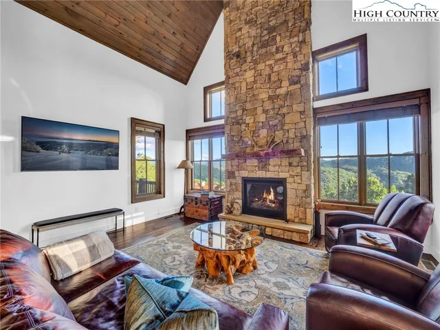 a living room with furniture a fireplace and window