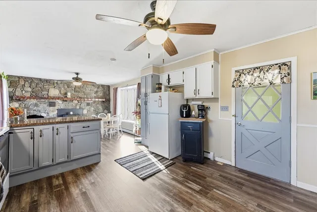 a kitchen with stainless steel appliances kitchen island granite countertop a refrigerator and microwave