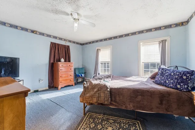 a bedroom with bed and window