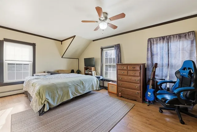 a bedroom with a bed closet and wooden floor