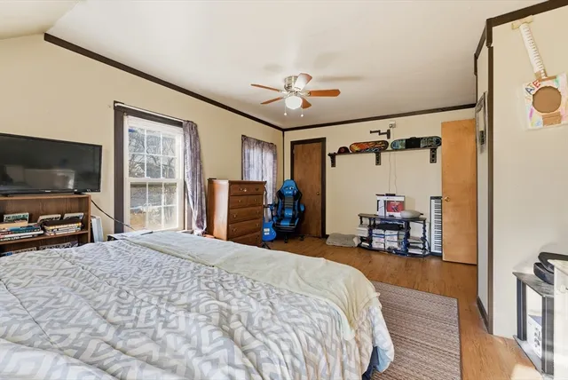 a bed room with a bed and a flat tv screen