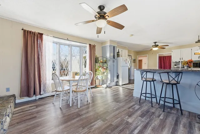 a view of a dining room with furniture and wooden floor