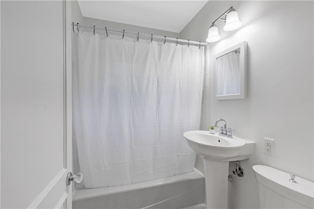 449 Nelson Ferry Road Decatur, GA 30030 - Photo 12 of 29 a bathroom with a sink a toilet and shower